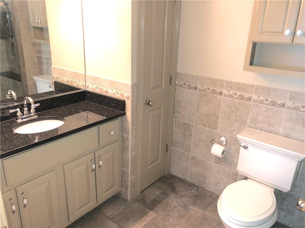 211 Adams Pointe Boulevard, Unit 10 Mars, PA 16046 - Photo 17 of 33 a bathroom with a granite countertop sink toilet and shower