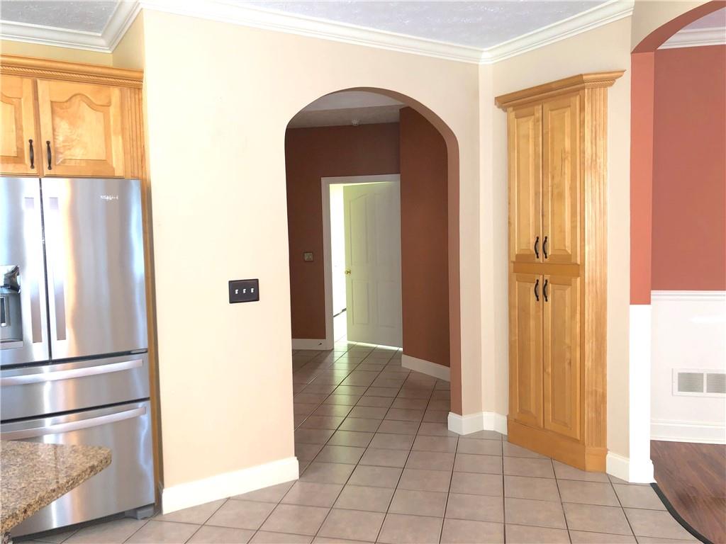 211 Adams Pointe Boulevard, Unit 10 Mars, PA 16046 - Photo 19 of 33 a view of a hallway with wooden floor and a living room