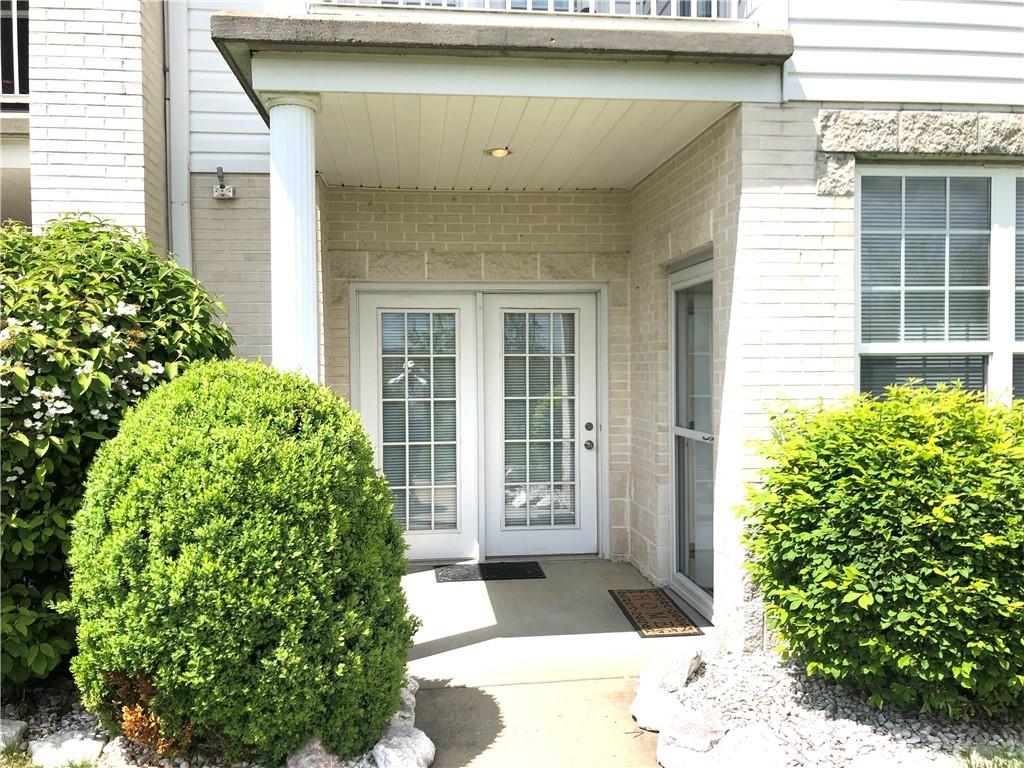 211 Adams Pointe Boulevard, Unit 10 Mars, PA 16046 - Photo 21 of 33 a front view of a house with a lots of flower plants