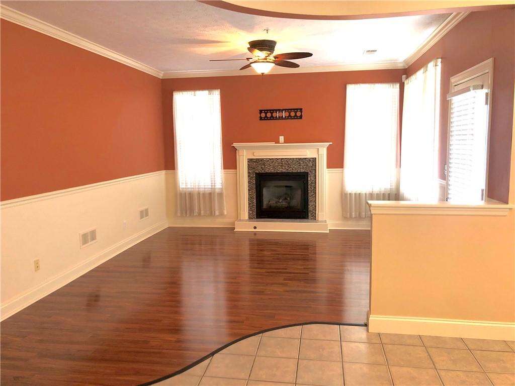 211 Adams Pointe Boulevard, Unit 10 Mars, PA 16046 - Photo 5 of 33 a view of a livingroom with wooden floor and a fireplace