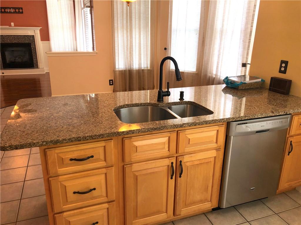 211 Adams Pointe Boulevard, Unit 10 Mars, PA 16046 - Photo 8 of 33 a kitchen with granite countertop a sink and cabinets