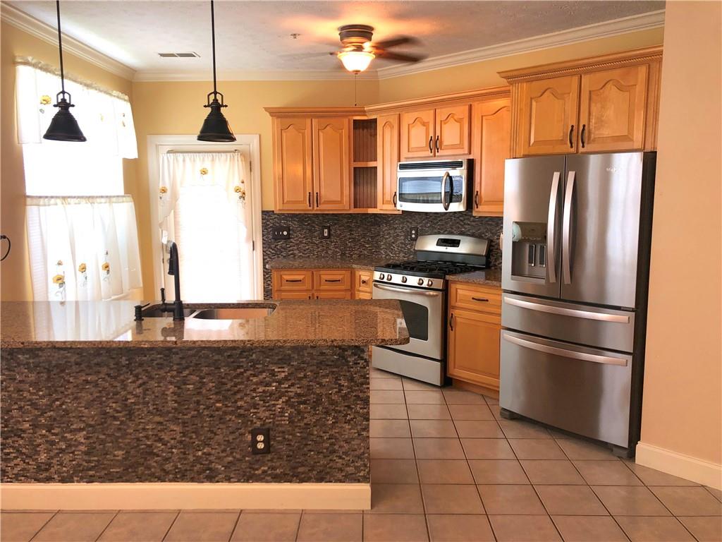 211 Adams Pointe Boulevard, Unit 10 Mars, PA 16046 - Photo 9 of 33 a kitchen with stainless steel appliances granite countertop a refrigerator a stove and a sink with wooden floor