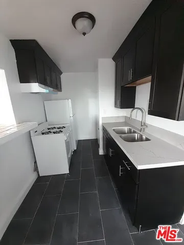 a kitchen with a sink appliances and cabinets