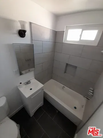 a bathroom with a bathtub and a toilet