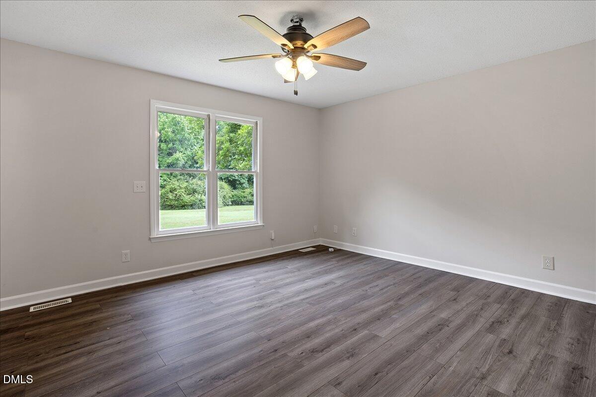 805 Rand Road Garner, NC 27529 - Photo 29 of 38 an empty room with wooden floor and windows