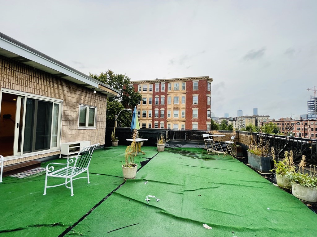 99 St Marys Street, Unit 99 Brookline, MA 02446 - Photo 13 of 14 a view of a house with a backyard porch and sitting area