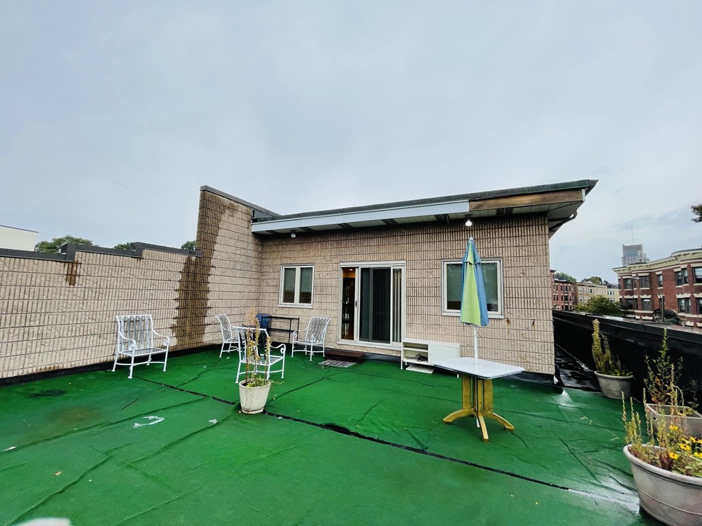 99 St Marys Street, Unit 99 Brookline, MA 02446 - Photo 14 of 14 a view of a house with backyard