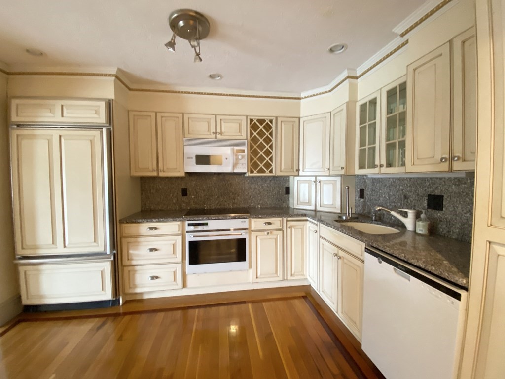 99 St Marys Street, Unit 99 Brookline, MA 02446 - Photo 3 of 14 a kitchen with stainless steel appliances granite countertop a stove a sink and a refrigerator