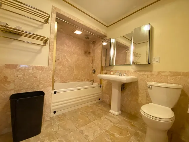 a bathroom with a toilet a sink and bathtub