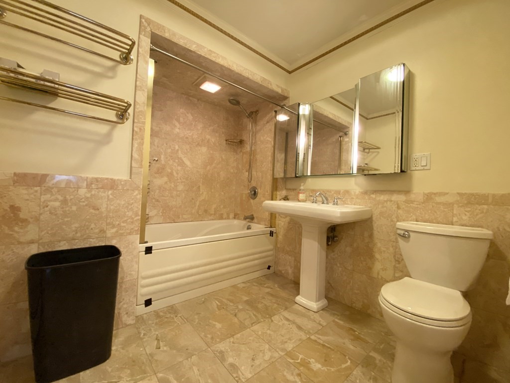 99 St Marys Street, Unit 99 Brookline, MA 02446 - Photo 7 of 14 a bathroom with a toilet a sink and bathtub