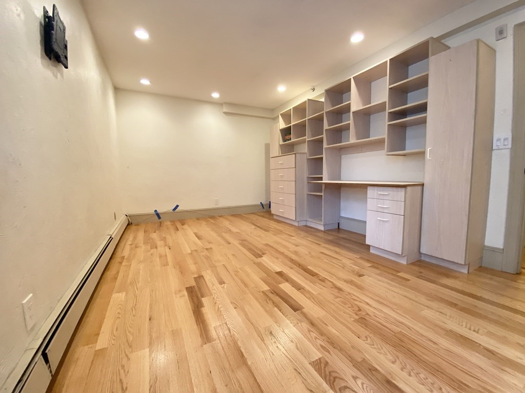 99 St Marys Street, Unit 99 Brookline, MA 02446 - Photo 10 of 14 a view of a room with wooden floor and a ceiling fan