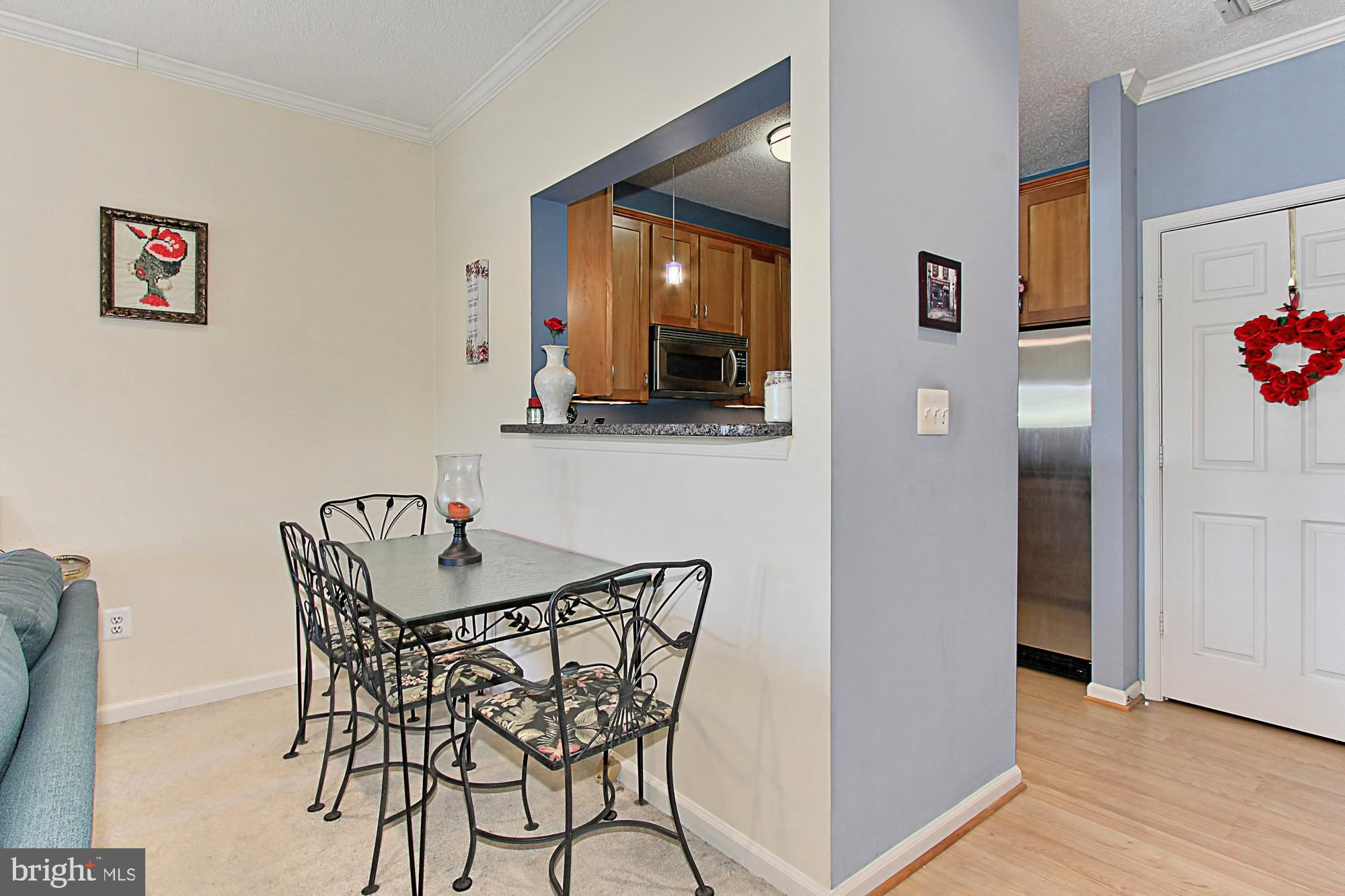 1708 Lake Shore Crest Drive, Unit 24 Reston, VA 20190 - Photo 10 of 29 Kitchen with a Breakfast Bar Opens to Dining Area