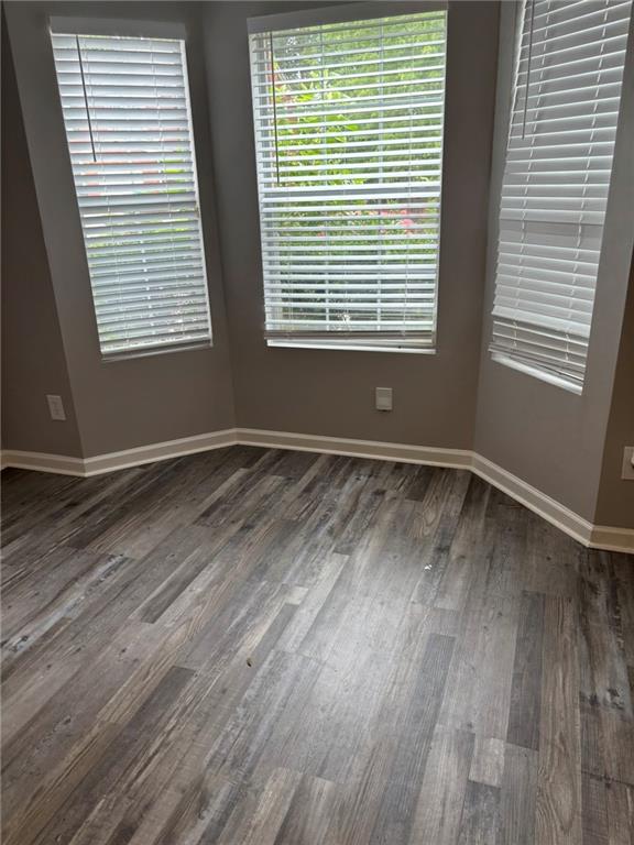 5739 Windfall Lane Lithonia, GA 30058 - Photo 8 of 36 a view of an empty room with wooden floor and a window