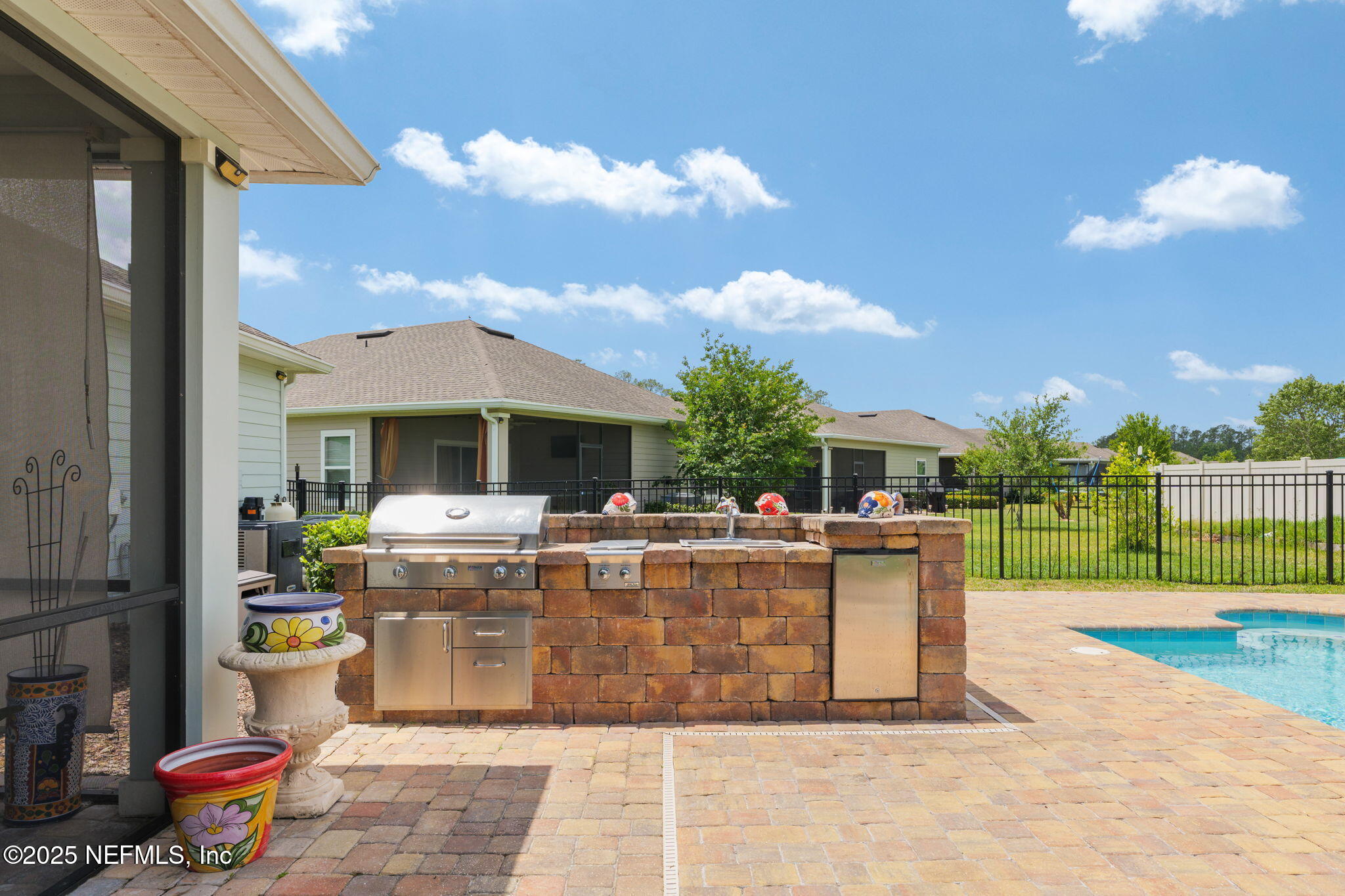 124 Tintamarre Drive St. Augustine, FL 32092 - Photo 16 of 40 a view of a patio with table and chairs potted plants and a palm tree