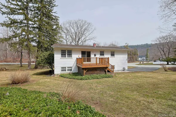 a view of a house with a yard and sitting area