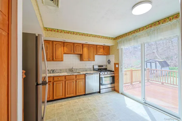 a kitchen with stainless steel appliances granite countertop a stove and a sink