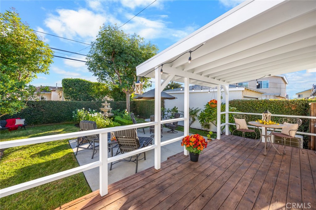 520 West 37th Street Long Beach, CA 90806 - Photo 16 of 50 a view of a deck with couches table and chairs and wooden floor