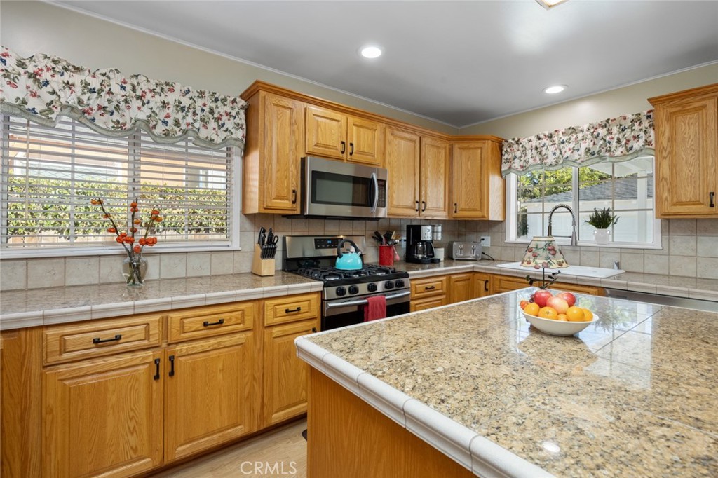 520 West 37th Street Long Beach, CA 90806 - Photo 34 of 50 a kitchen with stainless steel appliances granite countertop sink stove top oven and microwave