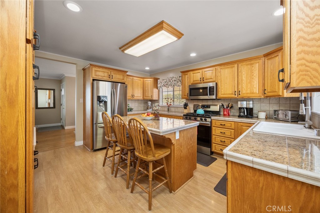 520 West 37th Street Long Beach, CA 90806 - Photo 35 of 50 a kitchen with stainless steel appliances granite countertop a refrigerator stove microwave and sink