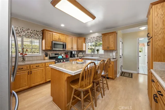 a view of washer and dryer with kitchen in the background