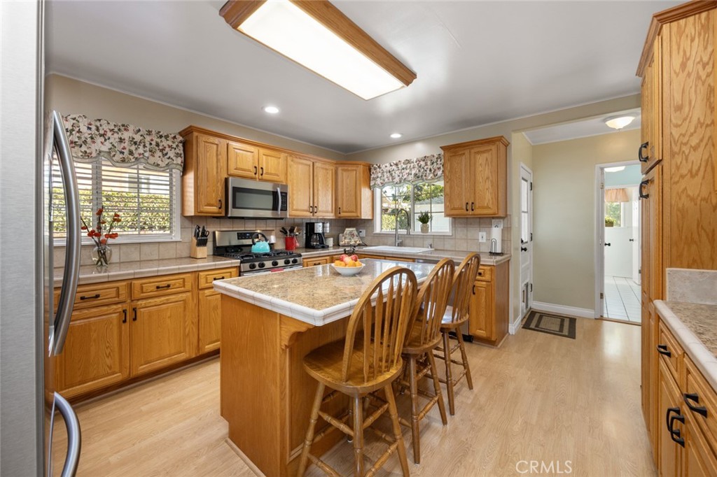 520 West 37th Street Long Beach, CA 90806 - Photo 36 of 50 a kitchen with stainless steel appliances granite countertop a stove a sink a refrigerator and a microwave