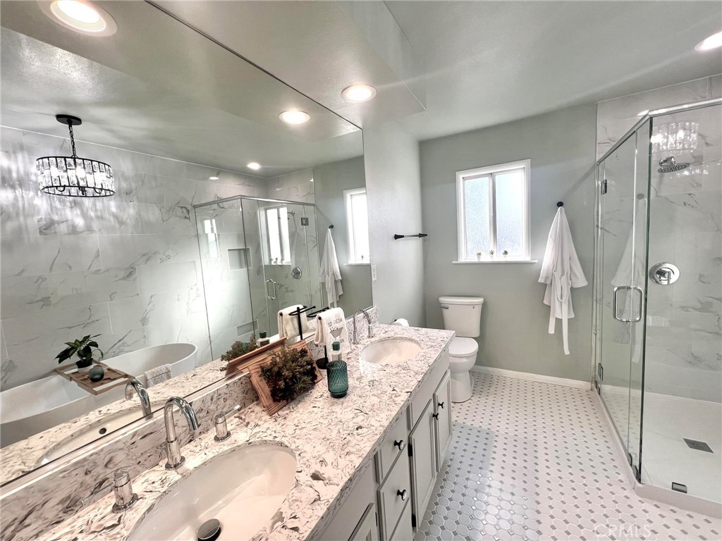 520 West 37th Street Long Beach, CA 90806 - Photo 7 of 50 a bathroom with a granite countertop sink a toilet a mirror and shower