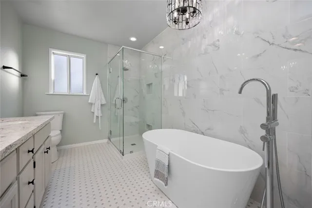 a white bath tub sitting next to a white toilet