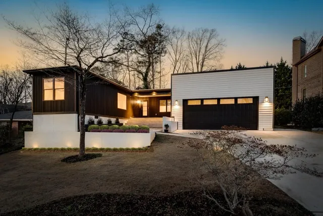 a view of house with yard and garage