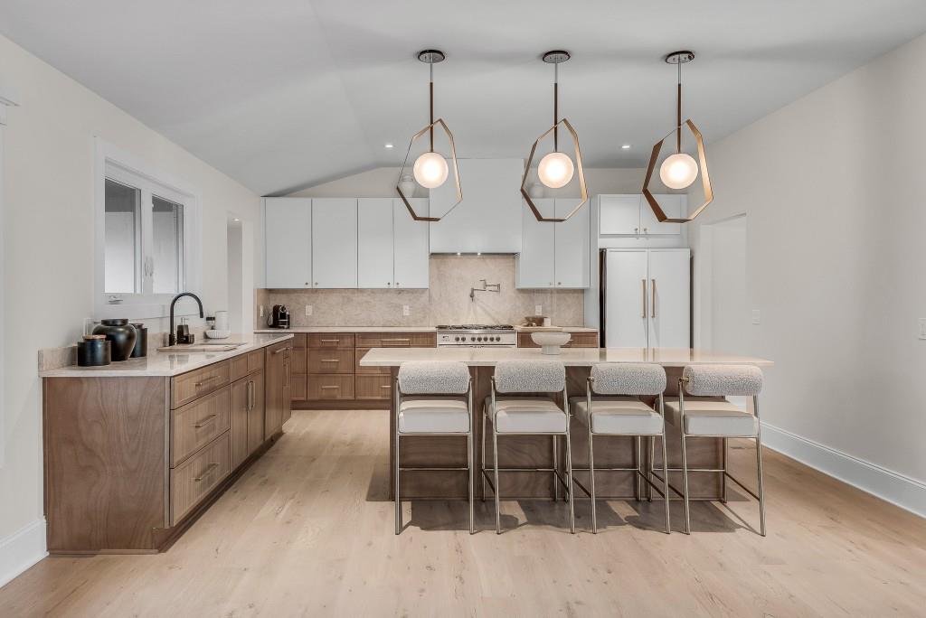 2362 Greenglade Road Northeast Atlanta, GA 30345 - Photo 17 of 39 a kitchen with stainless steel appliances granite countertop a sink a counter space a large window and chairs