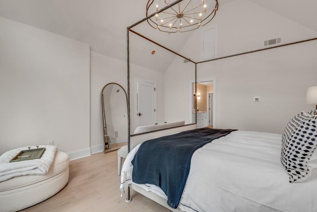 2362 Greenglade Road Northeast Atlanta, GA 30345 - Photo 5 of 39 a bedroom with a bed and a chandelier