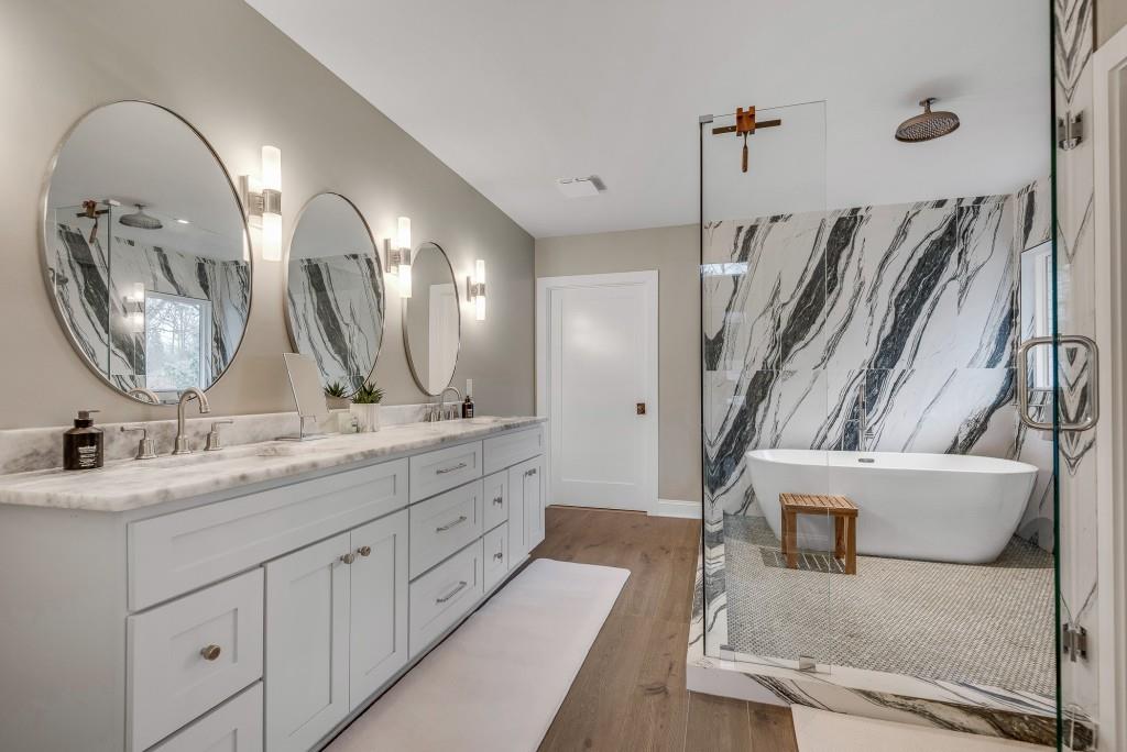 2362 Greenglade Road Northeast Atlanta, GA 30345 - Photo 6 of 39 a spacious bathroom with a granite countertop sink a mirror and a shower
