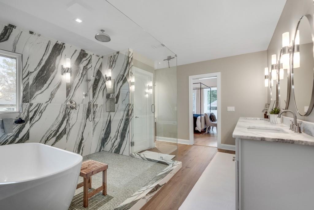 2362 Greenglade Road Northeast Atlanta, GA 30345 - Photo 10 of 39 a spacious bathroom with a granite countertop sink a toilet a mirror and shower