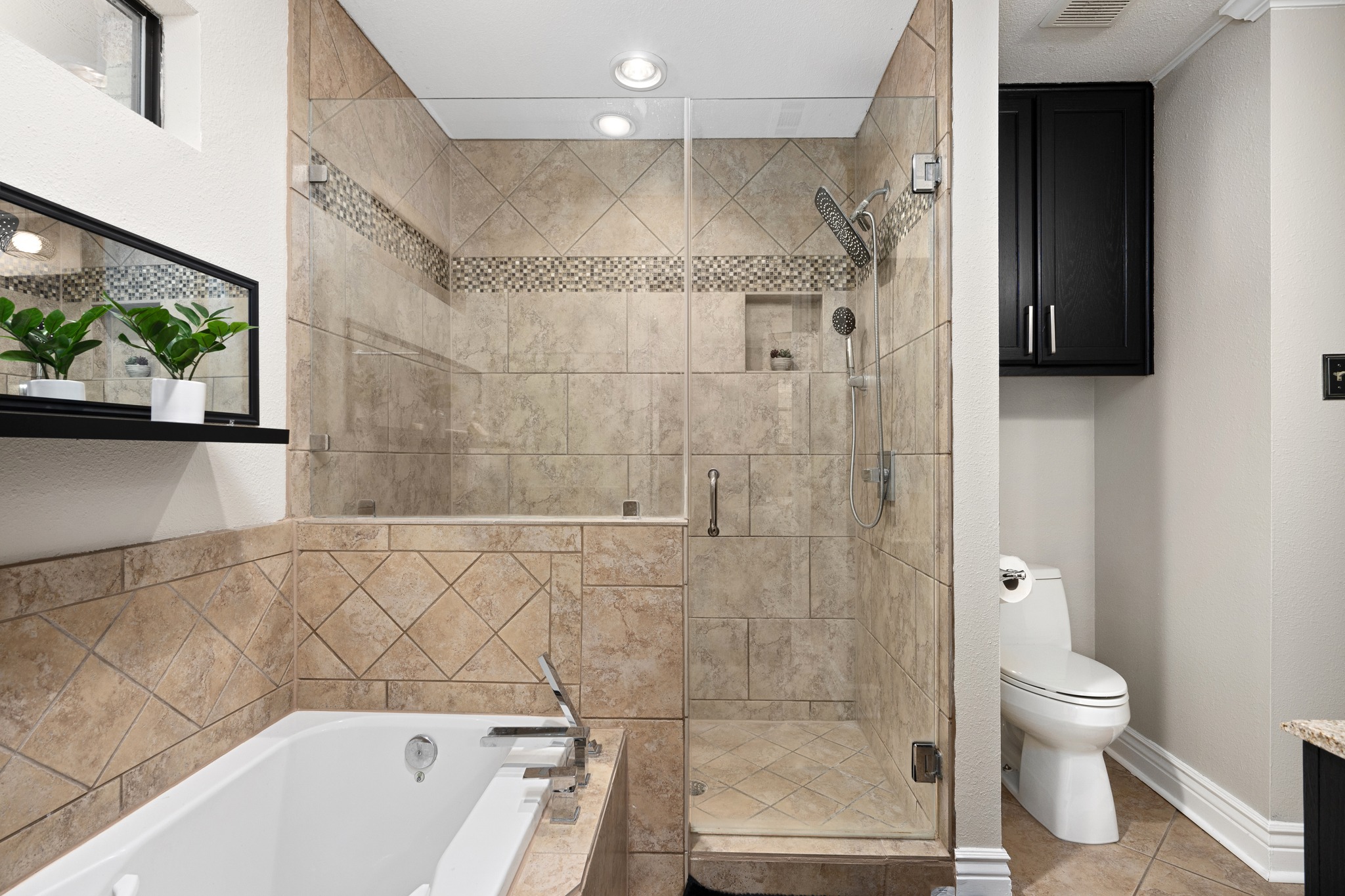 3908 Valley View Round Rock, TX 78681 - Photo 18 of 39 The primary ensuite features a walk-in shower, soaking tub, and tile surround for a bathroom that feels practical and polished.