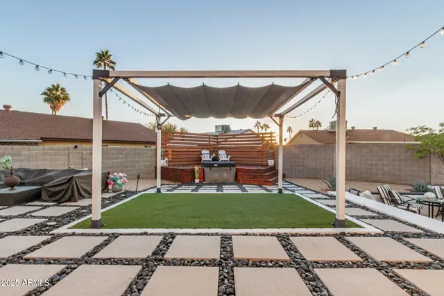a view of a patio with a table and chairs