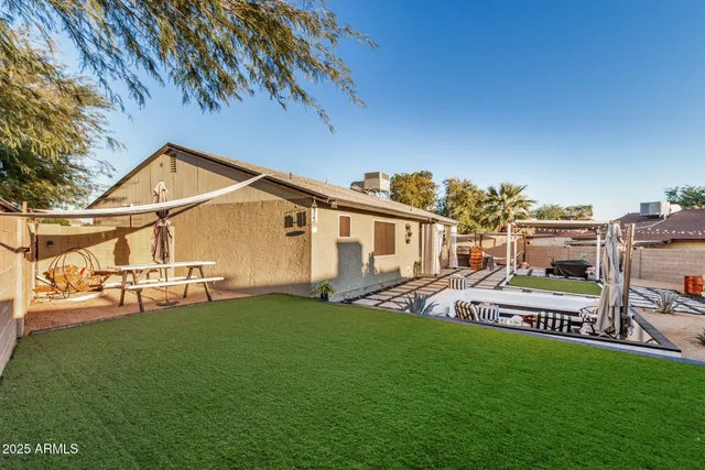a view of a house with a yard and sitting area