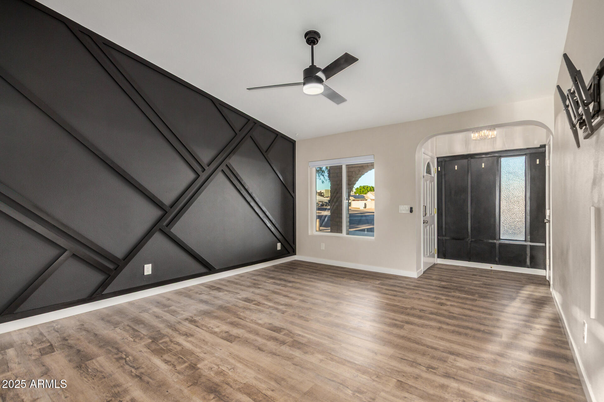 421 East Wickieup Lane Phoenix, AZ 85024 - Photo 2 of 24 a view of an empty room with wooden floor and a window