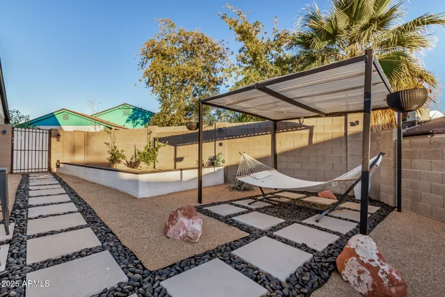 a view of a patio with table and chairs and potted plants
