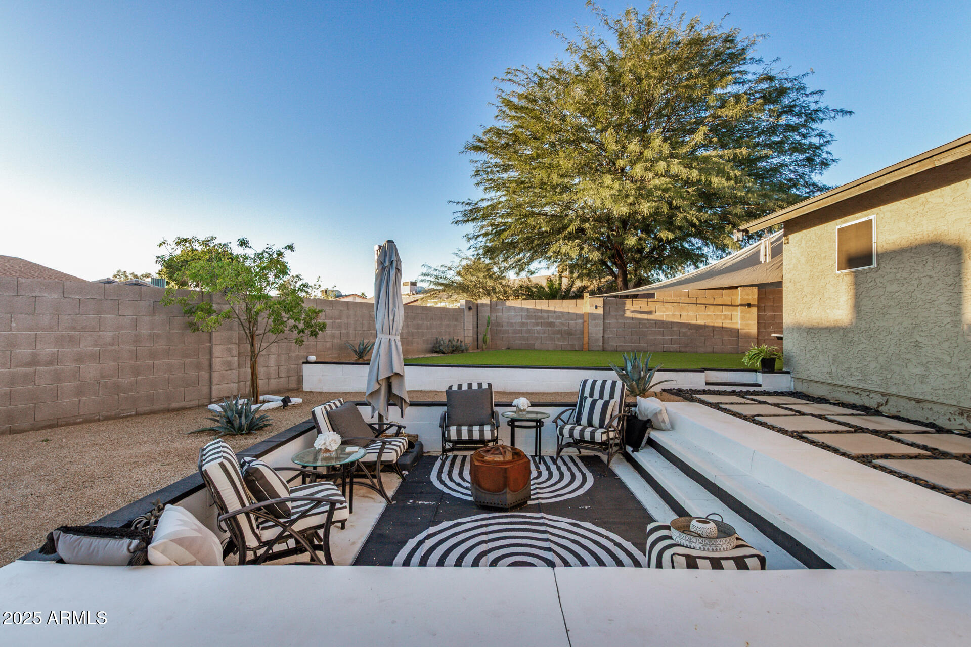 421 East Wickieup Lane Phoenix, AZ 85024 - Photo 23 of 24 a view of a patio with table and chairs and potted plants