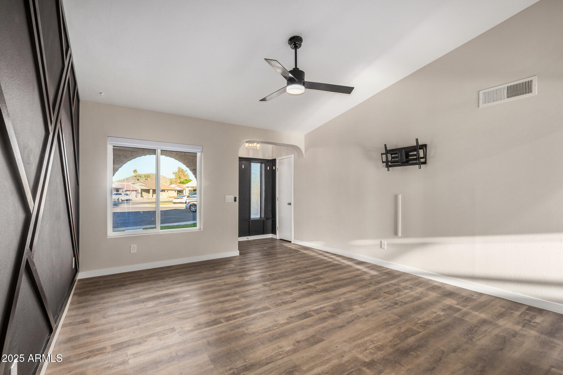 421 East Wickieup Lane Phoenix, AZ 85024 - Photo 3 of 24 an empty room with wooden floor and windows