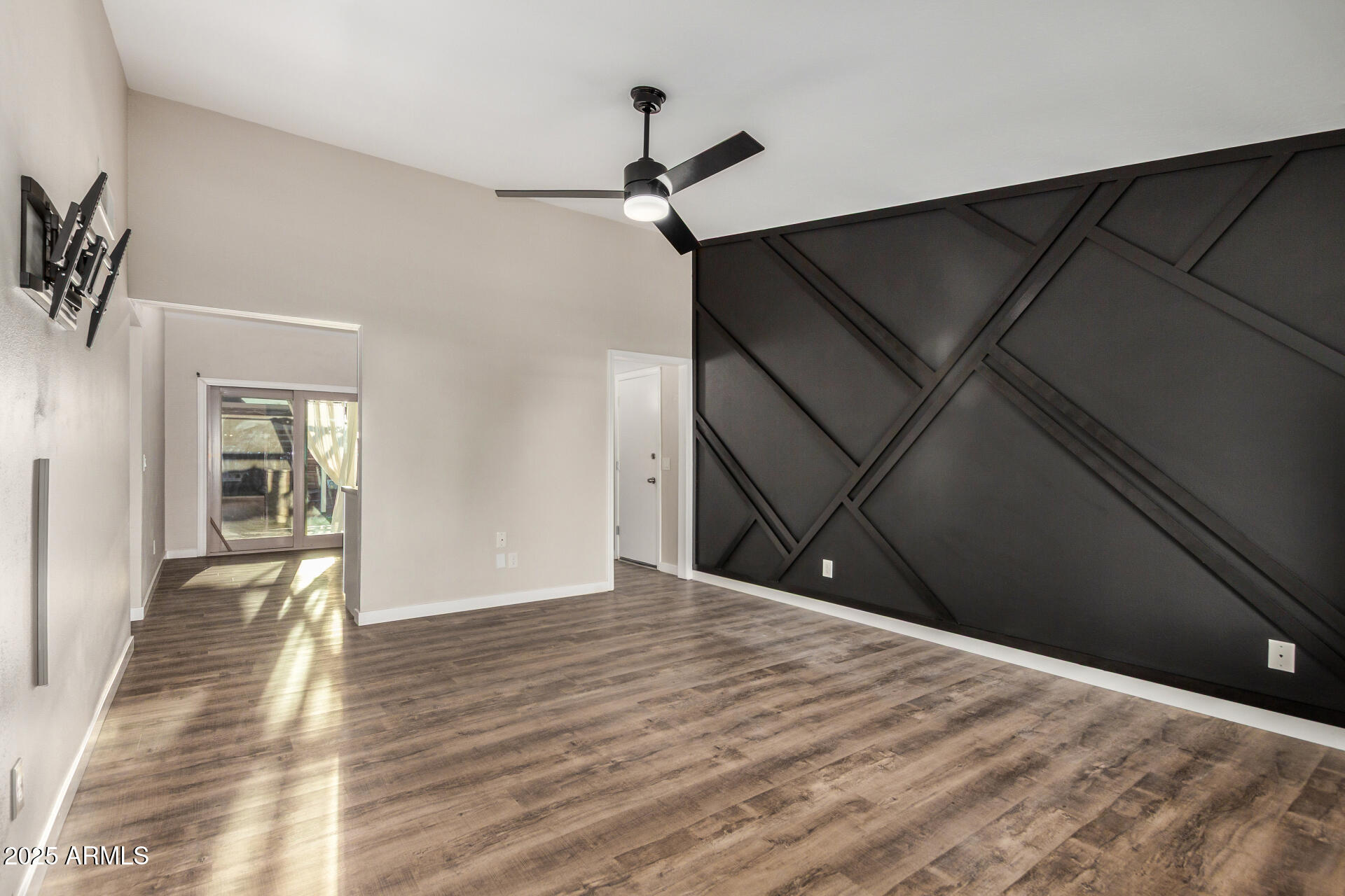 421 East Wickieup Lane Phoenix, AZ 85024 - Photo 4 of 24 a view of a livingroom with wooden floor and a ceiling fan