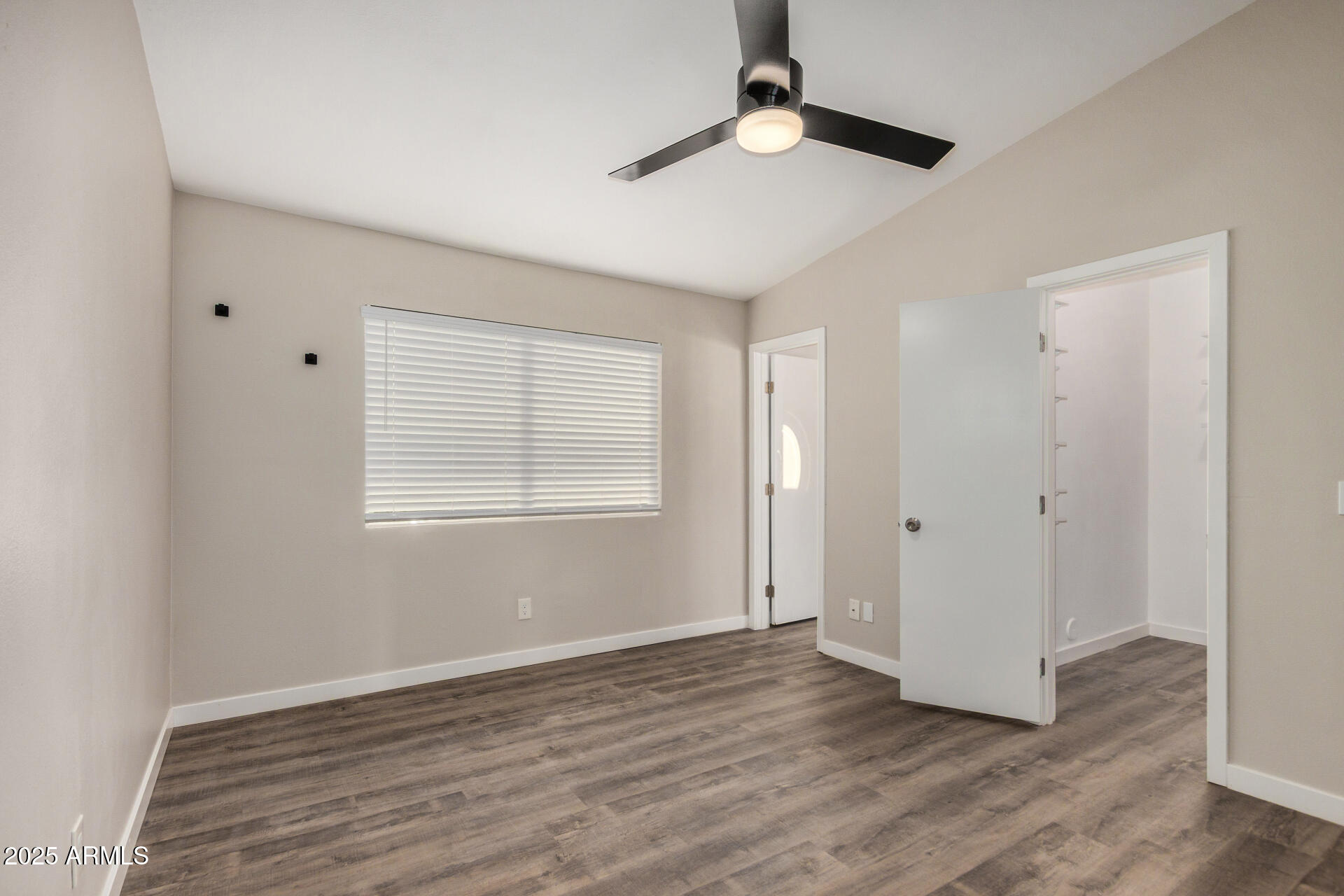 421 East Wickieup Lane Phoenix, AZ 85024 - Photo 9 of 24 an empty room with wooden floor and windows