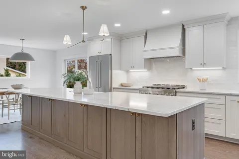 a kitchen with kitchen island white cabinets and white appliances