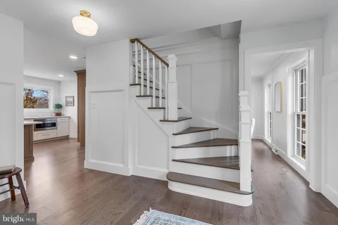 a view of entryway and hall with wooden floor