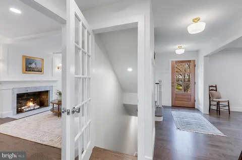 a view of a livingroom with wooden floor a fireplace and window
