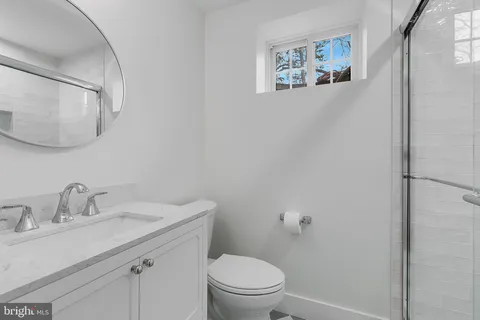a bathroom with a sink mirror and toilet