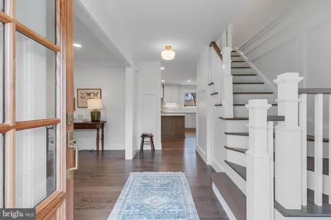a view of entryway and hall with wooden floor