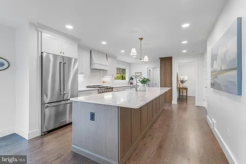 a kitchen with kitchen island a sink appliances and cabinets