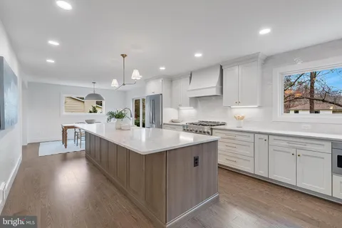 a kitchen with counter top space sink and center island