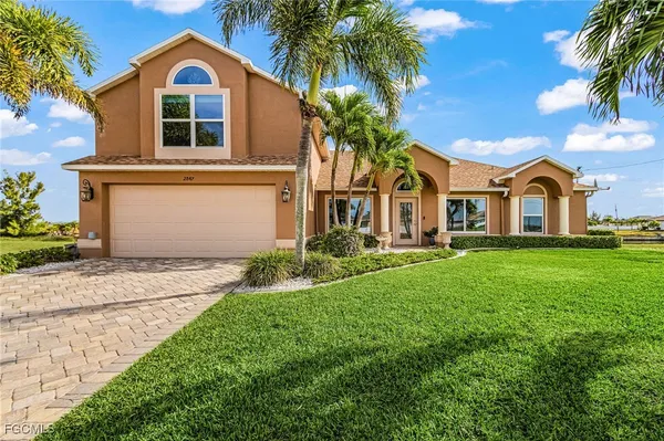 a front view of house with yard and green space
