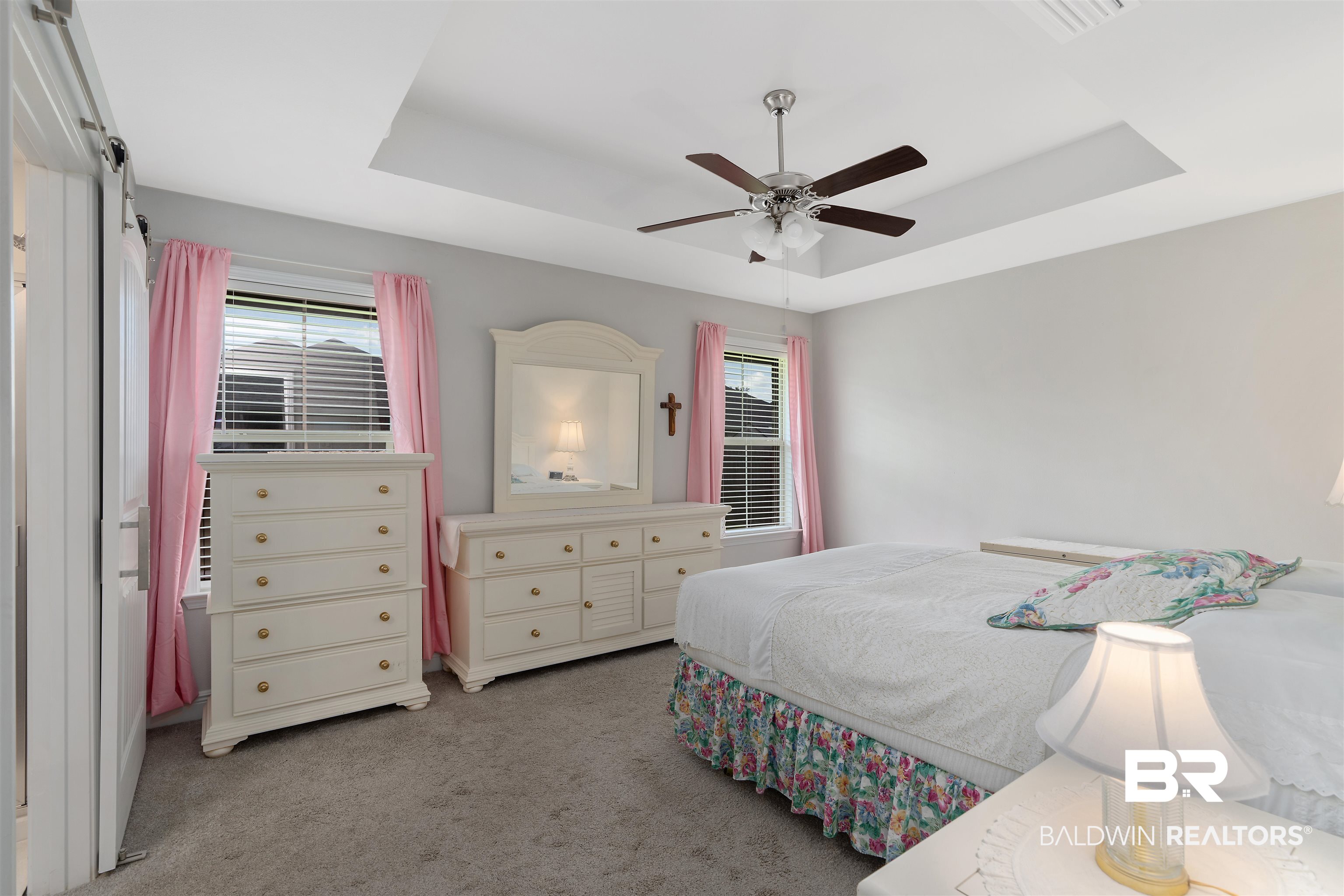 8823 Allay Lane Foley, AL 36535 - Photo 8 of 18 Carpeted bedroom with multiple windows, ceiling fan, and a raised ceiling